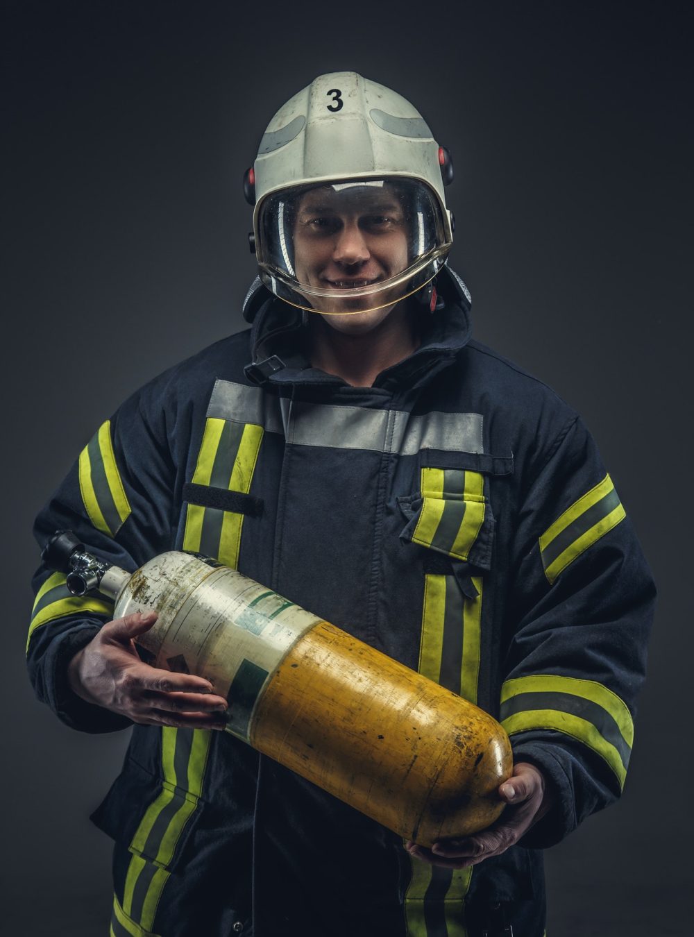 firefighter rescue holds yellow oxygen tank .jpg firefighter rescue holds yellow oxygen tank .jpg